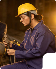 Woman in a yellow hard hat working with a wrench